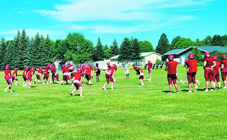 The Cardinals highschool football team practicing on the field on Monday