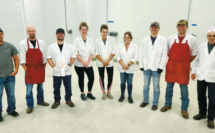 The Langdon Locker crew poses in their shiney new processing room. From left to right: Tyler Bodnar (owner), Josh Metzger (general manager), Dillon McMahon, Brittany Dulski, Danielle Brown, Sue Christianson,Wyatt Kartes, Logan Feil, and Darrell Metzger. Photo by Hilary Nowatzki.