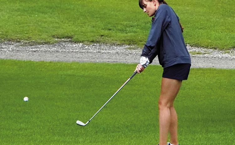 Lily Zimmer chips the ball up near the pin at the first Langdon meet hosted on Aug 11. Photo by Larry Stokke.