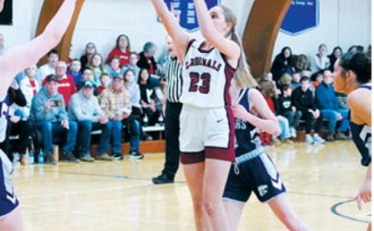 Hallie Overby sends one through the net in the Lady Cards win over the Cougars. Photo by Larry Stokke