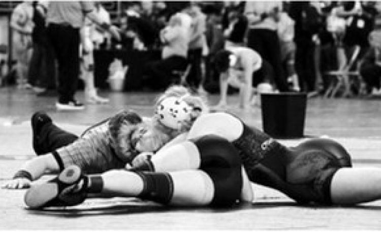 Charlotte Crowston, shown here pinning her opponent, placed 7th for the tournament in Fargo on Jan. 3. Photo by Larry Stokke.