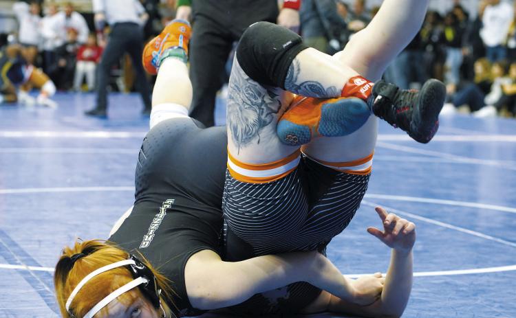 Marlie Stremick looks up at the referee as she pins her opponent, finishing in 6th place at the state tournament. Photo by Larry Stokke.