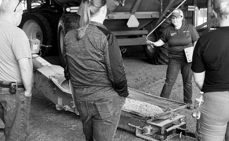 Angie Johnson, NDSU Extension farm and ranch safety specialist, explains safety procedures around an auger. (NDSU photo)