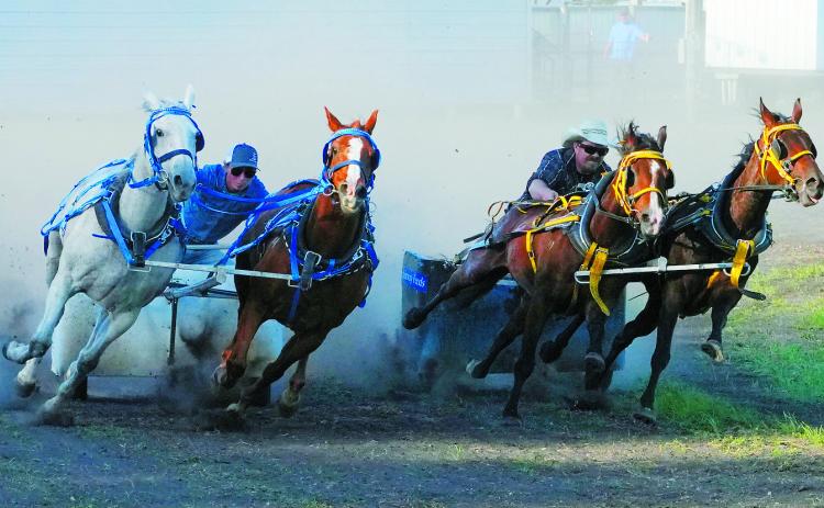 Josh Zaharia (left) races against Mike Henke (right) during the Chariot Races at the Hamilton Fair. Photo by Larry Stokke.