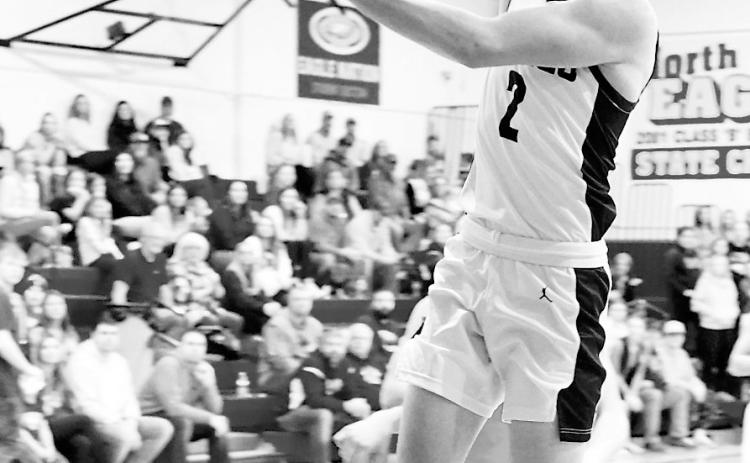 Kaden Moore lays in a basket to finish the win over the Tornadoes with 18 points. Photo by Larry Stokke.