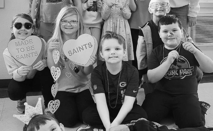 Our second grade class poses in front of our Giving Hearts Day photobooth. St. Alphonsus School photo.