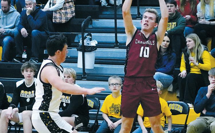 With his Grandmother and parents watching, Maddux Stremick nails one of his three-point baskets, finishing the game with 11 points in the win over the Aggies. Photo by Larry Stokke.