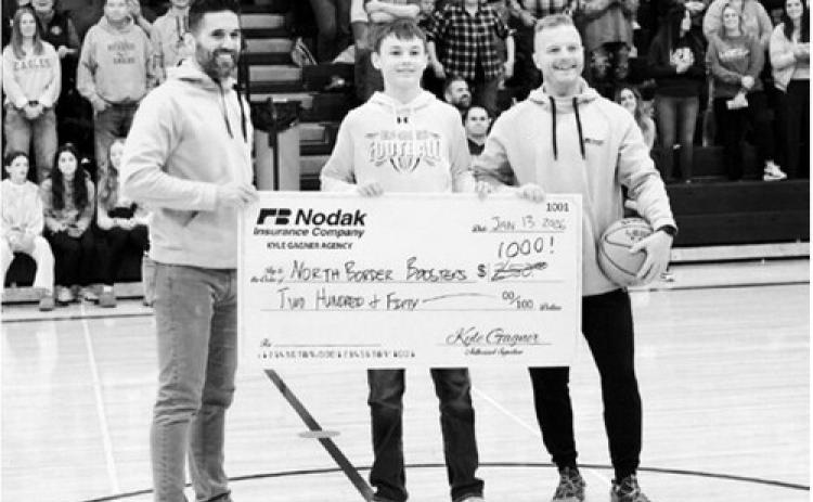 Kyle Gagner, Nodak Insurance of Cavalier and Ryan Beattie, Nodak Insurance of Langdon, are pictured with Asher Crosby and the donation that will be made to the North Border Boosters. Photo by Larry Stokke.