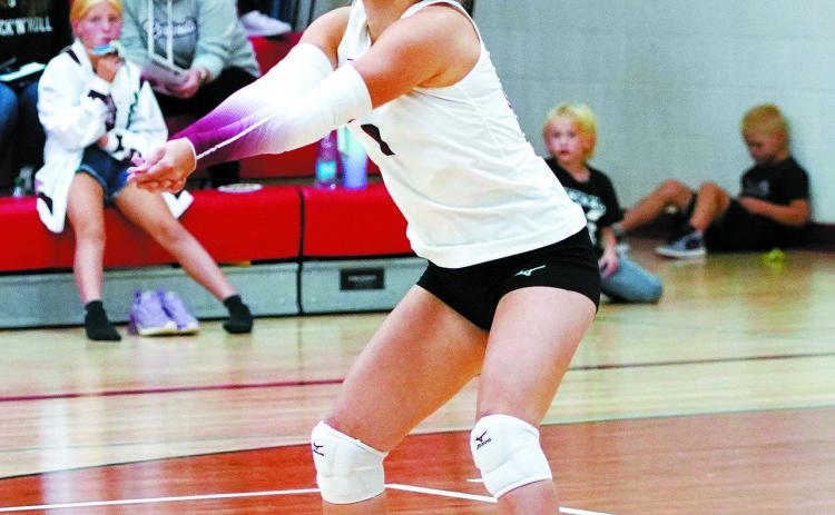 Raeleigh Ratzlaff digs the ball from the back row in the battle between Cavalier. Photo by Larry Stokke.