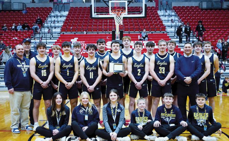 The North Border Eagles 2024-2025 boys basketball team with their 7th place trophy from the State B Tournament in Minot. Photo by Larry Stokke.