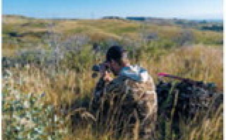 Bowhunter glassing in western North Dakota. Photo courtesy of ND Game and Fish