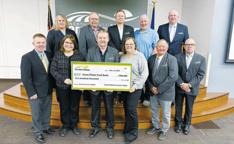 Pictured with NDFU President Mark Watne and the NDFU State Board of Directors are Marcia Paulson (at left), GPFB philanthropy officer, and Michelle Watne, Harvesting Hope Campaign honorary co-chair.
