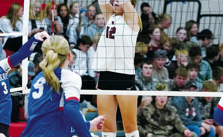 Kemi Morstad stuff blocks a Wildcat player in the Cards' sweep of a three set win on Oct. 7 in Langdon. Photo by Larry Stokke.