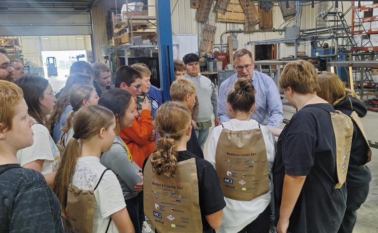 Cavalier seventh graders are shown how Bordertown Retail Systems produces custom racks for retailers.