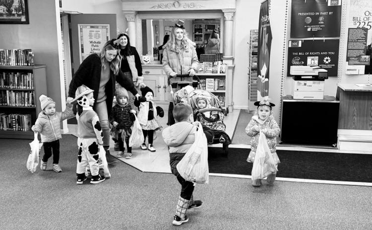Trick or treaters visiting the library on Halloween.