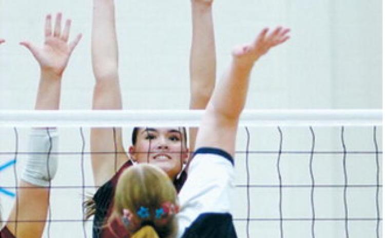 Taya Feist goes up for a big block against the North Prairie Cougars during the Cardinals’ homecoming volleyball match Oct. 8 in Langdon. Photo by Larry Stokke