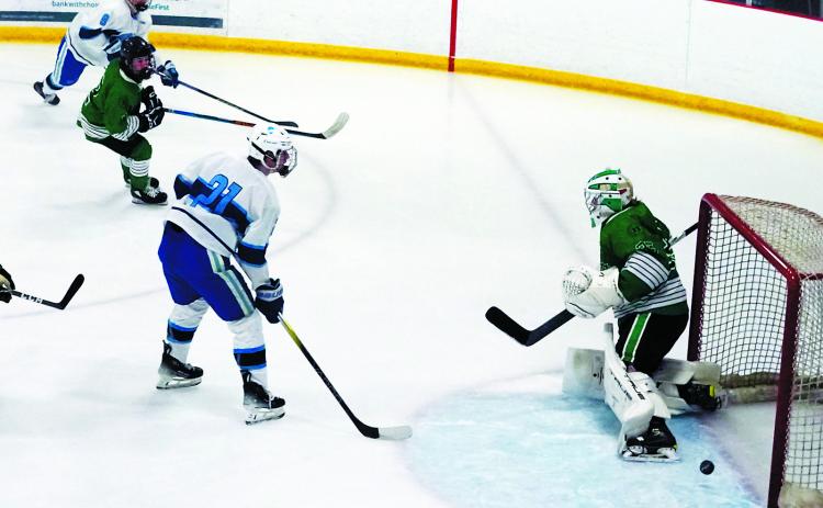 Devils Lake Royals #8 Brady Regner fires a shot from the right of the goalie and scores the first goal of the game against the UND Mens Club on Feb. 1. Photo by Larry Stokke.
