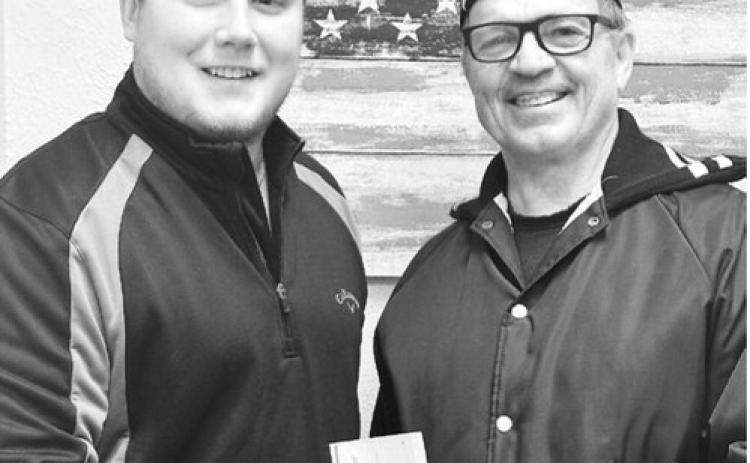 Xavier Mitchell of Horizon Financial Bank presents a check to Kevin Dawley of the Sarles American Legion. The $500 donation is from Horizon Financial Bank and its board of directors.