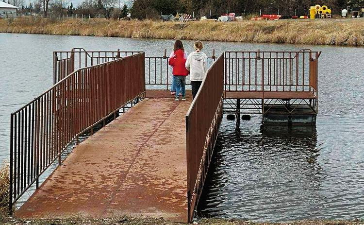 Holden and Zowie Kreklau enjoying the fishing pier at the Langdon City Pond.