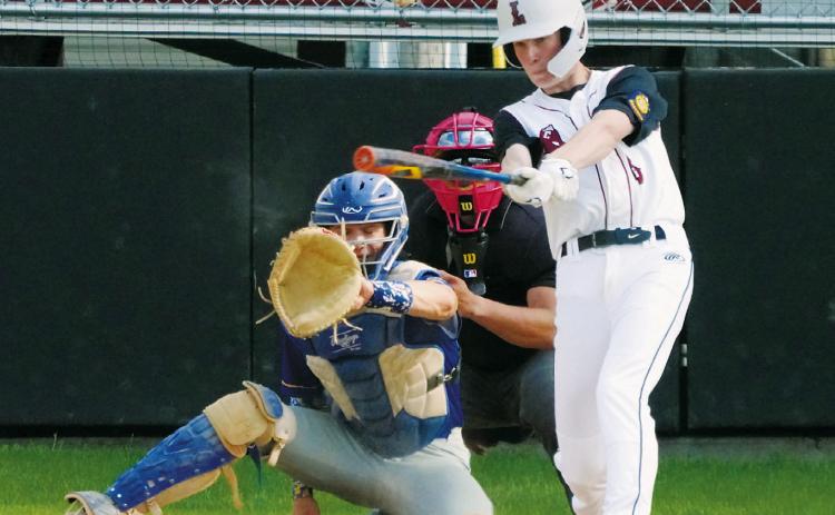 Tyson Gemmill connects with the ball and gets a base hit against Hatton/Northwood. Photo by Larry Stokke.
