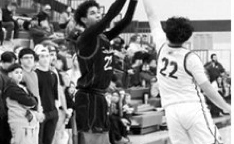 Shaun Kelso fires off a three-point shot against the Spoilers in Grafton Feb 20th. Photo by Larry Stokke