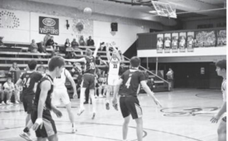 Kade Schafer launches a shot outside the 3-point line. Photo by Ashley Schafer.