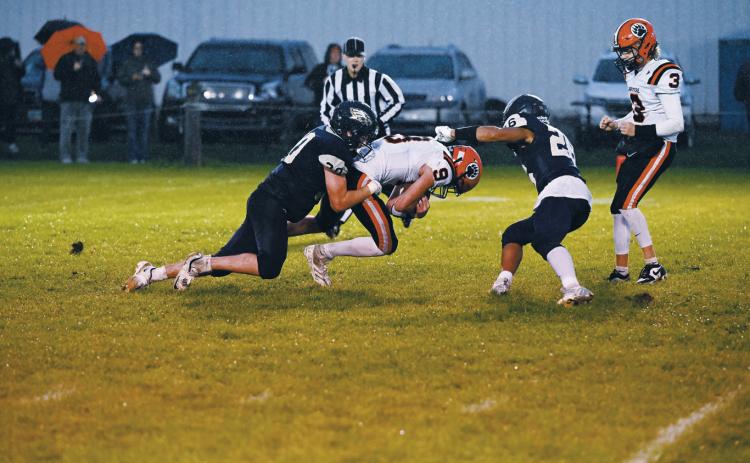 A strong defensive effort from Brody Berg and Trevor Moore as they halt the run. Photo by Ashley Schafer.