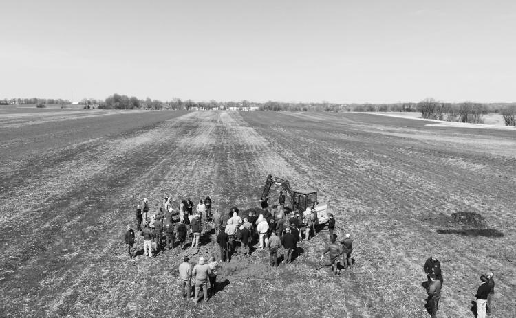Farmers view a soil pit as part of an on-farm soil health research project. (NDSU photo)