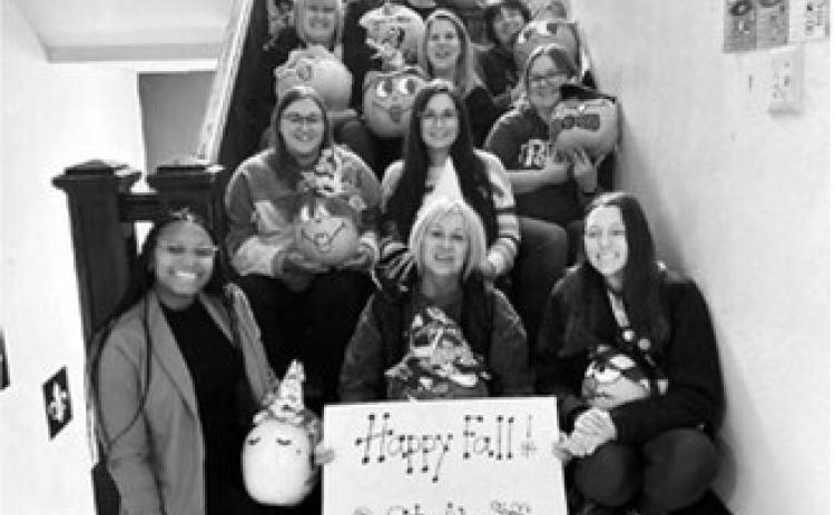 St. Alphonsus principal and teachers are pictured with painted pumpkins they received as gifts in the fall. Submitted photo