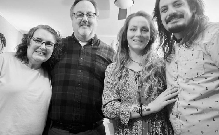 Mom, Joel, me, and Phil posing for a photo on Thanksgiving.
