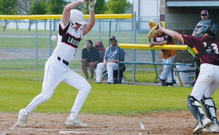 Austin Wenzel takes first base after being hit by a pitch during Langdon's game against Grafton. Photo by Larry Stokke