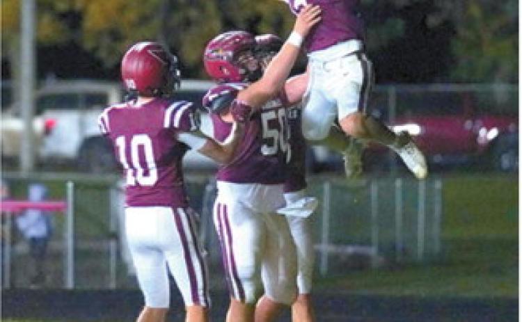 Gavin Trottier celebrates with teammates after scoring a touchdown in the Cardinals’ win over Carrington. Photo by Larry Stokke