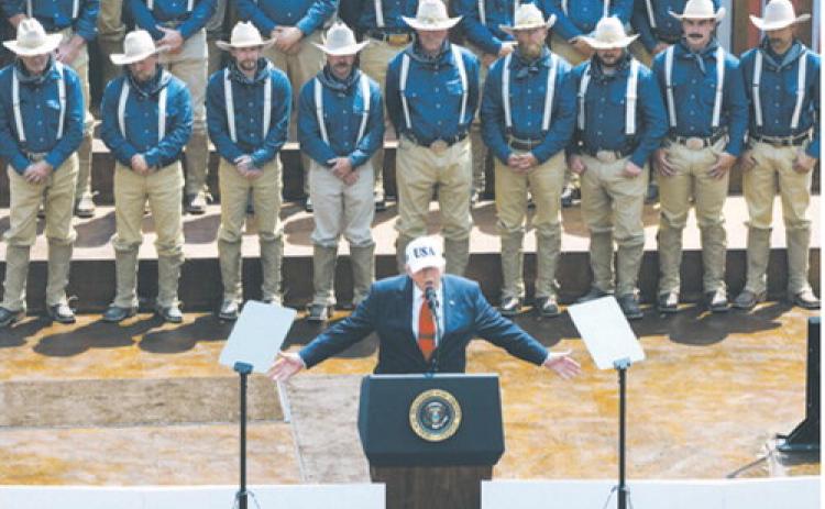 President Donald Trump speaks to a crowd July 1, 2026, at the Burning Hills Amphitheatre in Medora, N.D., in front of people portraying Theodore Roosevelt’s Rough Riders. (Photo by Kyle Martin/For the North Dakota Monitor)