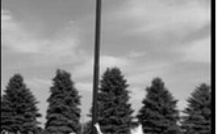 Pinky Padden stands beside the flagpole he purchased and installed at the Lebanon Cemetery east of Langdon. Padden also provided the flag and light and painted the Eastern Star emblem at the base as a tribute to all veterans. Photo submitted by Kevin Stein
