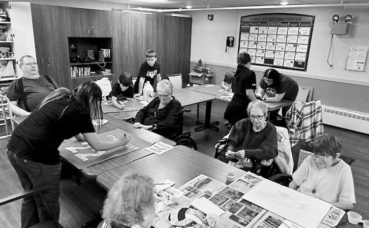 The North Border Walhalla sixth graders making posters with PNC residents.