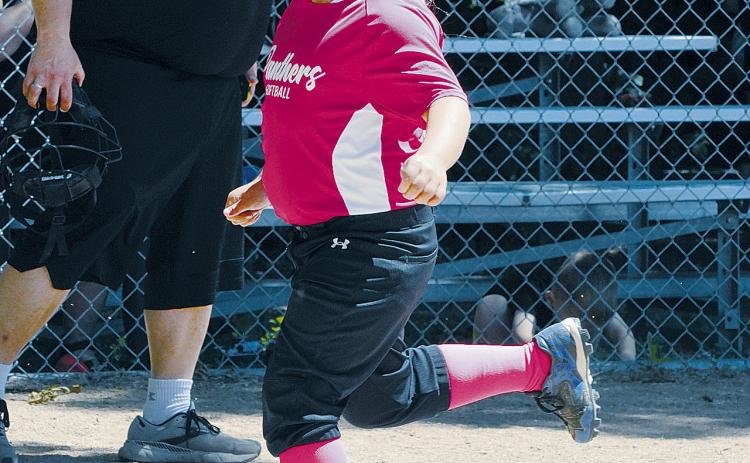 Andrea Finnson crosses home plate and scores a run for the Pink Panthers. Photo by Larry Stokke.