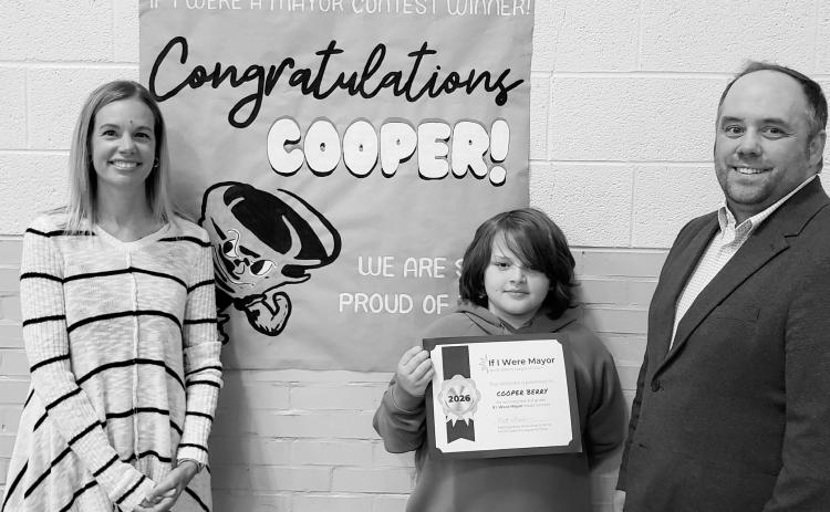 Cooper Berry, a third-grade student at Cavalier School, holds his award after winning the North Dakota League of Cities’ statewide “If I Were Mayor” essay contest.