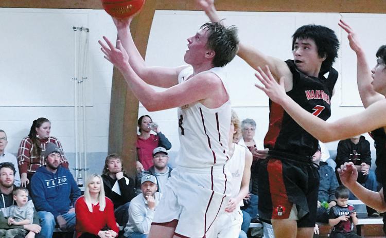 Player of the Game Levi Swanson had three 3 point baskets and finished with 16 points in the win over Warwick. Photo by Larry Stokke.