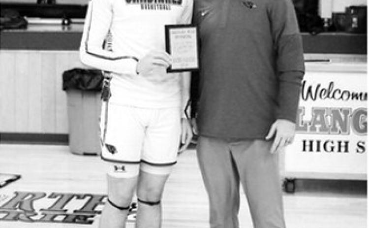 Eastyn Schafer received a plaque celebrating the 1000th point in his career. Photo by Larry Stokke