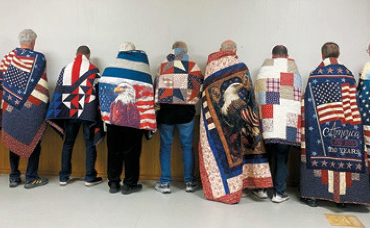 Recipients proudly display their Quilts of Valor following a recent presentation by American Legion Post 98. The handmade quilts are awarded to veterans touched by war as a symbol of comfort and appreciation for their service. Submitted photo