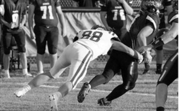 Colten Hein tackles the Hornet ball carrier in Harvey Sept. 4. Photo by Larry Stokke