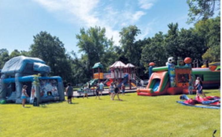 Kids enjoy the inflatable attractions set up in Riverside Park during Walhalla's Fourth of July celebration. Borderland Press Photo