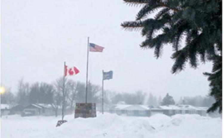 Winds whipped the flags in Langdon on Saturday , Jan. 31 as another Alberta Clipper moved through the area. Sarah Hinnenkamp / Borderland Press