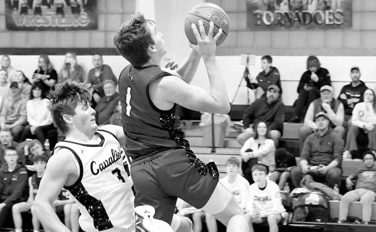 Eastyn Schaefer drops in one of his 14-points worth of baskets against Cavalier. Photo by Larry Stokke.