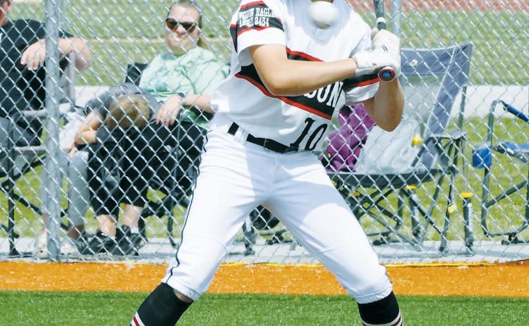 Bensen Fetsch launches a ball across the field in the game against Park River. Photo by Larry Stokke.