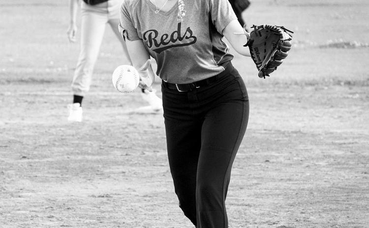 Graci Witzel delivers a strike in the Reds win in Langdon. Photo by Larry Stokke.