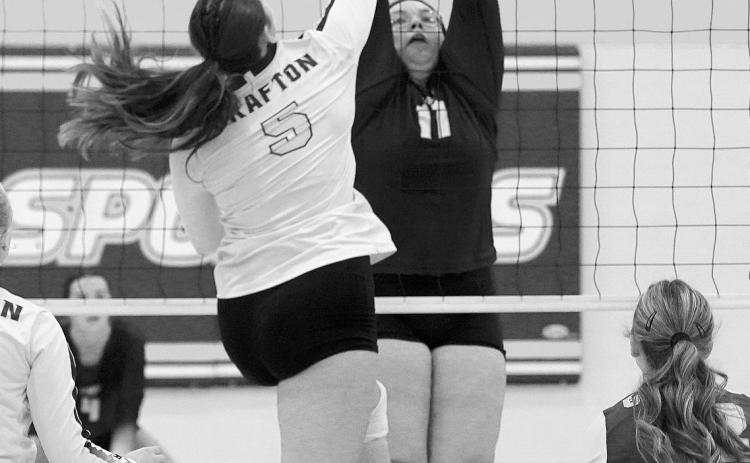 Jaelyn Forrey with a stuff block in the Eagles game against the Spoilers. Photo by Larry Stokke.