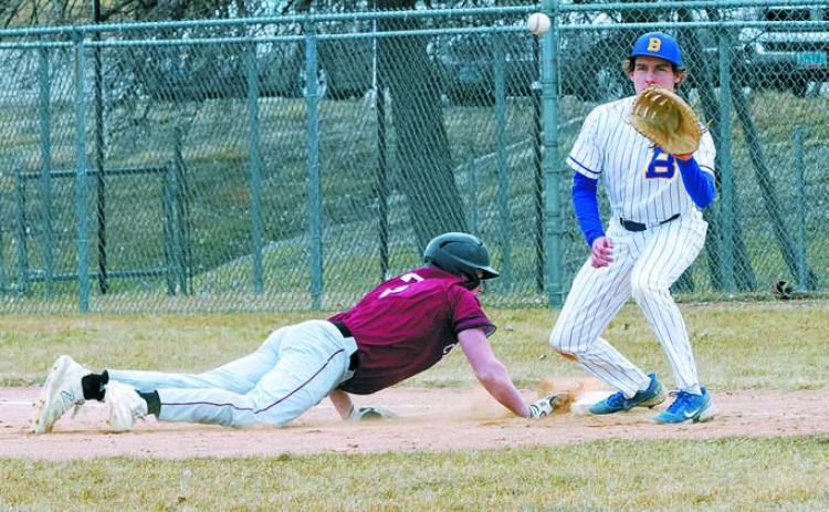 Dawson Hein tags the bag beating the ball back to the first baseman. Photo by Larry Stokke.