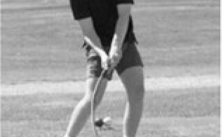 Langdon Area/Munich golfer Korbyn Rollness swings through a shot during regional golf competition. Photo by Larry Stokke