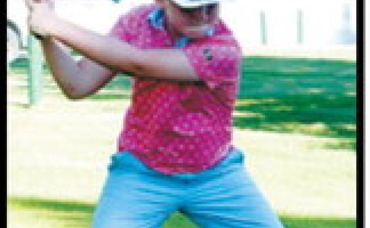 A young golfer tees off during the St. Alphonsus School Adult-Child Golf Tournament on July 13 at the Langdon Country Club. Photo by Larry Stokke